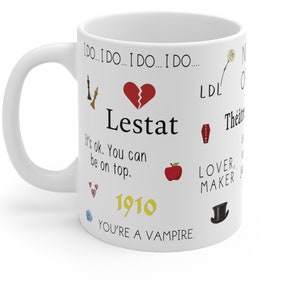 May include: White coffee mug with black text that reads 'I do... I do... I do... I do... Lestat It's ok. You can be on top. 1910 You're a vampire.' The mug also has various colorful icons including a broken heart, a chess piece, a red apple, a coffin, a top hat, a rose, and hearts.