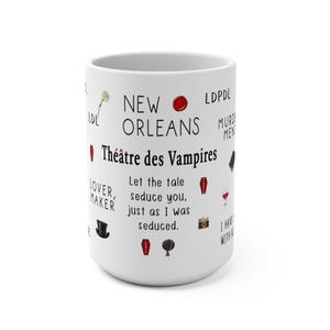 K&ouml;nnte beinhalten: Wei&szlig;er Keramikbecher mit den Worten "NEW ORLEANS Th&eacute;&acirc;tre des Vampires" in schwarzer Schrift. Der Becher zeigt verschiedene kleine Illustrationen und S&auml;tze, darunter einen Sarg, ein Weinglas und den Text "Let the tale seduce you, just as I was seduced."