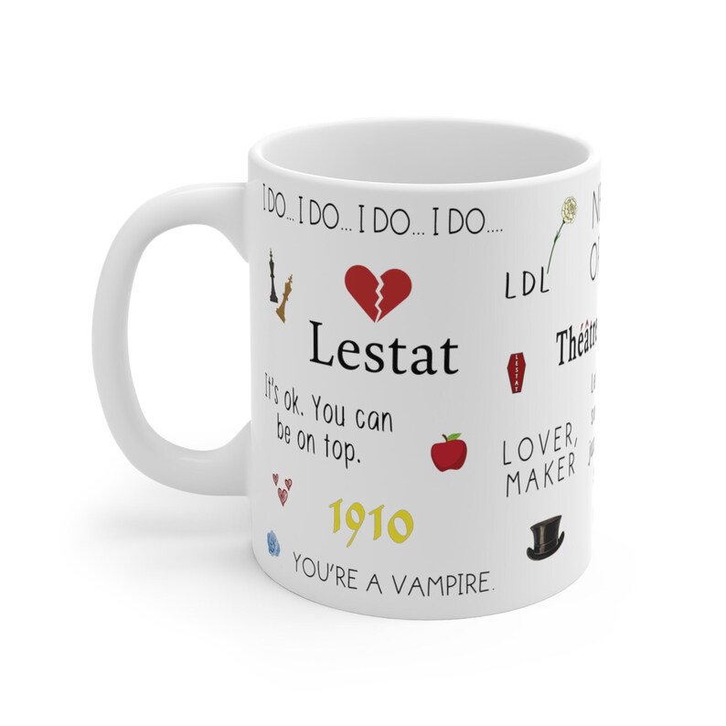 May include: White coffee mug with black text that reads 'I do... I do... I do... I do... Lestat It's ok. You can be on top. 1910 You're a vampire.' The mug also has various colorful icons including a broken heart, a chess piece, a red apple, a coffin, a top hat, a rose, and hearts.
