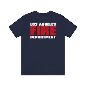 May include: A navy blue t-shirt with the text "LOS ANGELES FIRE DEPARTMENT" printed on the back in white and red letters.