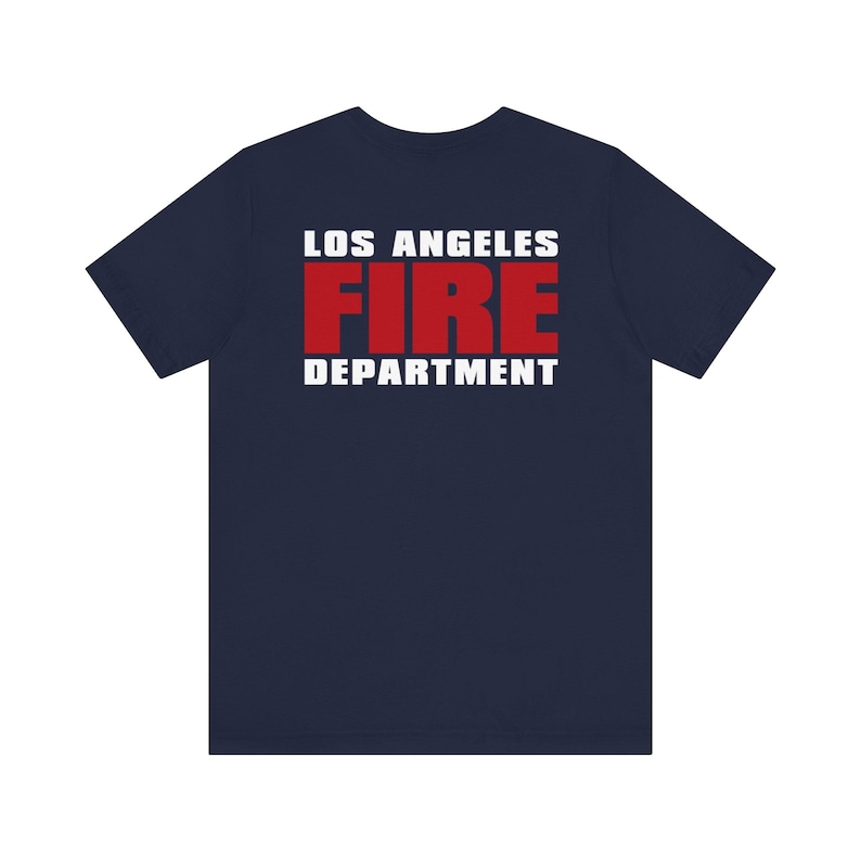 May include: A navy blue t-shirt with the text "LOS ANGELES FIRE DEPARTMENT" printed on the back in white and red letters.