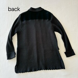 May include: Black ribbed knit cardigan with a black velvet collar and a scalloped hem. The cardigan has a back label that says "back".