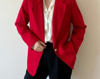 May include: A red blazer with a single gold button closure. The blazer has a classic, tailored fit and is made of a smooth, high-quality fabric.