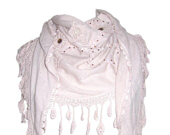 May include: A pale pink scarf with a crocheted border and fringe. The scarf has a floral design with brown buttons and beads.