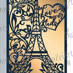 May include: A navy blue laser-cut design featuring the Eiffel Tower, floral elements, and a heart with the words "Love never fails." The design is set against a gold background.