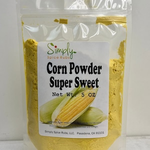 May include: A clear plastic bag filled with yellow corn powder. The label reads "Corn Powder Super Sweet" with an illustration of corn. The net weight is 5 oz. The brand name is Simply Spice Rubs.