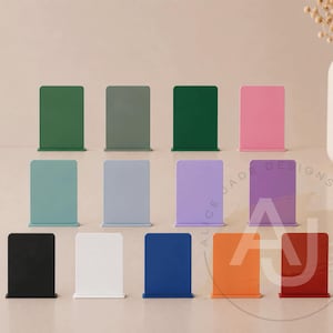 May include: A collection of colorful, rectangular bookends in various shades, including green, pink, and blue. The bookends are arranged in rows, showcasing a range of hues for home or office decor. The bookends are made of metal.