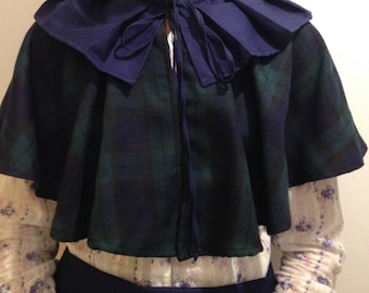 May include: A blue and green plaid cape with a ruffled blue collar and a tie closure. The cape is made of a soft, comfortable fabric and has a relaxed fit.
