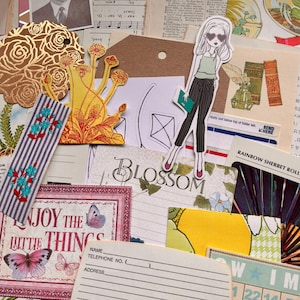 May include: A collection of assorted paper ephemera including a vintage black and white portrait, a gold foil rose die-cut, a yellow floral illustration, a sticker of a person in sunglasses, a striped bookmark, and cards with text like Blossom and Enjoy the Little Things.