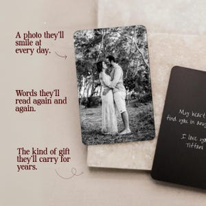 May include: A rectangular metal wallet card featuring a black and white photograph of a couple standing outdoors. A second black card displays white handwritten text that reads: My heart will find you in any lifetime. I love you, Tiffani.