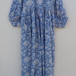 May include: A blue and white floral print dress with a gathered waist and puffed sleeves.