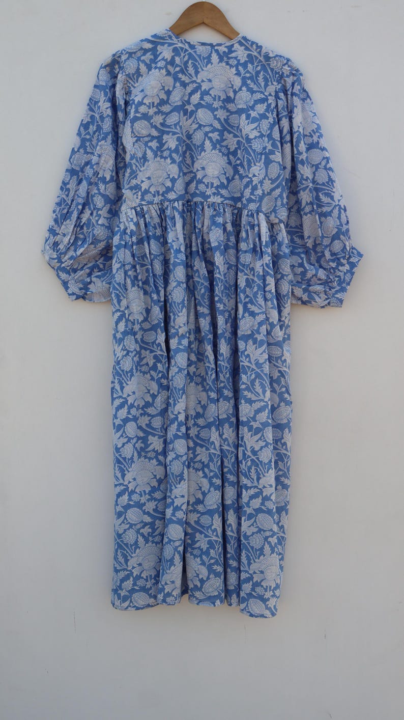 May include: A blue and white floral print dress with a gathered waist and puffed sleeves.