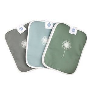May include: Three pot holders with a white dandelion design. The pot holders are green, blue, and grey.