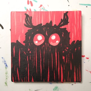 May include: A black and red painting of a monster with large, red eyes. The monster is depicted with a furry, black body and a red background.
