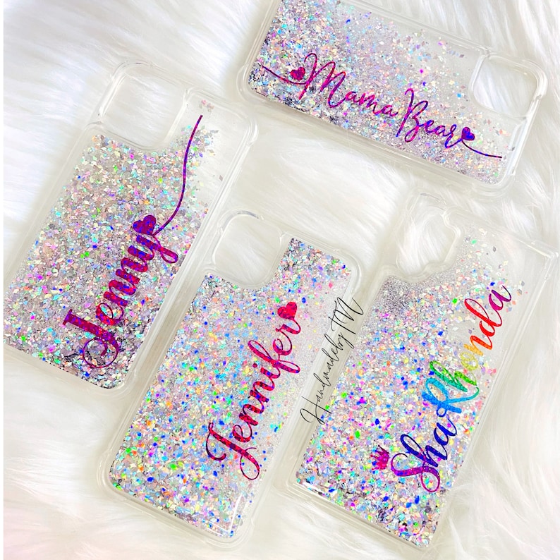 May include: Four clear phone cases with glitter and personalized names. The names are "Jennifer", "Shaunda", "Jenny", and "Mama Bear".