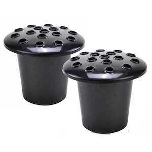 May include: Two black plastic flower frog inserts for grave vases. Each piece features a cylindrical base and a wide, rounded top with multiple circular openings designed to hold flower stems securely in place for floral arrangements.