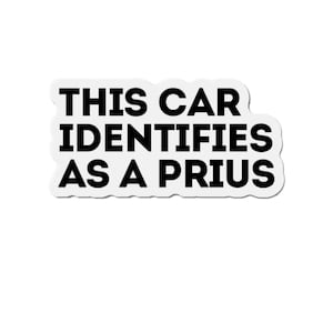 May include: A white sticker with black text that reads "This car identifies as a Prius".