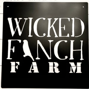 May include: Black metal sign with white lettering that reads "Wicked Fanch Farm". The sign features a silhouette of a bird.
