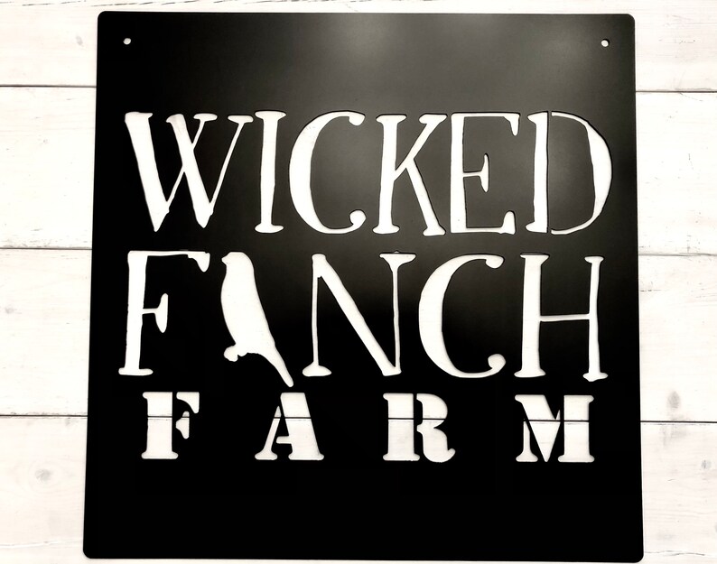 May include: Black metal sign with white lettering that reads "Wicked Fanch Farm". The sign features a silhouette of a bird.