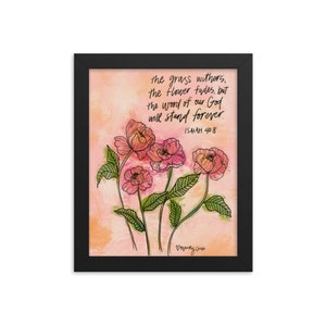May include: A framed print with a watercolor background and pink flowers. The print features the text "the grass withers, the flower fades, but the word of our God will stand forever. ISAIAH 40:8"