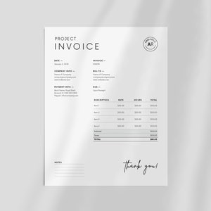 May include: A black and white invoice template with the words "Project Invoice" at the top. The invoice includes sections for date, invoice number, company info, bill to, payment info, due date, description, rate, hours, and total. The invoice also includes a section for notes and a thank you message.