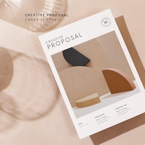 May include: A white document titled "CREATIVE PROPOSAL" with a modern design. The document features abstract shapes in black, tan, and brown. The words "CANVA TEMPLATE" are above the document. The background is a light pink.
