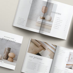 Peut inclure: Une brochure de proposition commerciale au design minimaliste. La couverture présente un gros plan de trois objets décoratifs sur une surface texturée. Le texte "BUSINESS NAME proposal" est imprimé en noir sur fond blanc.