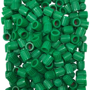 May include: A bulk pack of 100 green plastic valve stem caps for car tires.