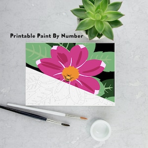 May include: Printable paint by numbers kit featuring a pink flower with a bee in the centre. The flower is surrounded by green leaves on a black background.