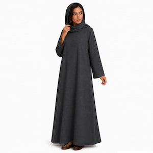May include: A dark gray hooded dress with long sleeves and a flowing skirt. The dress has a high neckline and a hood that drapes over the shoulders. The fabric appears to be a soft, medium-weight material.