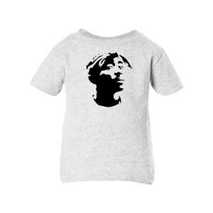May include: A gray short-sleeved t-shirt with a black silhouette of a person's head.