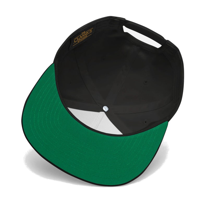 May include: A black and green baseball cap with a white interior. The cap has a black brim and a green crown. The cap has a label on the front that says "The Classics".