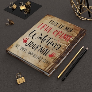 May include: A brown journal with a distressed, vintage look. The cover features the text "This is my True Crime Watching Journal" with red handprints and the words "Tips, Tricks, and Helpful Ideas".