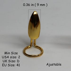 May include: Gold-colored adjustable ring with a pointed top. The ring is 0.36 inches (9 mm) tall. The minimum size is USA size 2, UK size D, and EU size 41.
