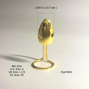May include: Gold ring with a teardrop-shaped setting. The ring is adjustable and has a minimum size of 6 (US), L 1/2 (UK), or 52 (EU). The ring is 0.54 inches (13.7 mm) tall.