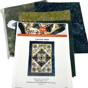 May include: A quilt-along kit featuring Boundless Batiks fabric from Craftsy. The kit includes fabric and a pattern for a quilt with a finished size of 56" x 90". The pattern is titled "Canyon Creek" and designed by Monique Dillard. The kit includes fabric in shades of green and blue.