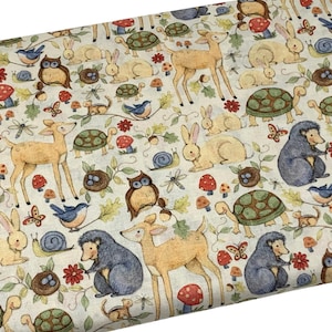 May include: A white fabric with a repeating pattern of woodland animals, including deer, rabbits, owls, hedgehogs, turtles, and mushrooms. The animals are illustrated in a whimsical style with muted colors.