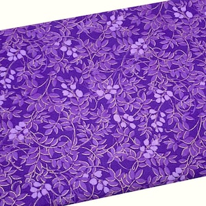 May include: Purple fabric with a repeating pattern of gold and purple leaves. The leaves are arranged in a vine-like pattern.