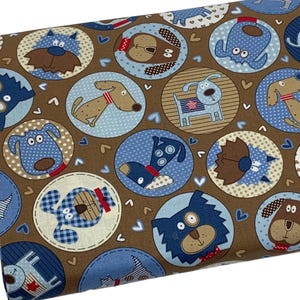 May include: Brown fabric with a repeating pattern of blue and brown dogs in circles. The dogs are wearing red collars and have different expressions. The background is brown with small white hearts.