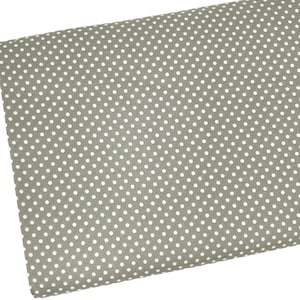 May include: A close-up of a gray fabric with a white polka dot pattern.