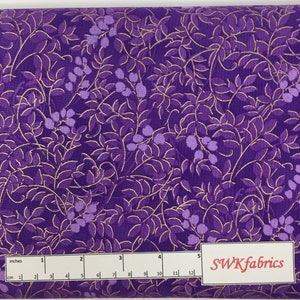 May include: Purple fabric with a gold leaf pattern. The fabric is 12 inches wide and has a ruler for measuring.