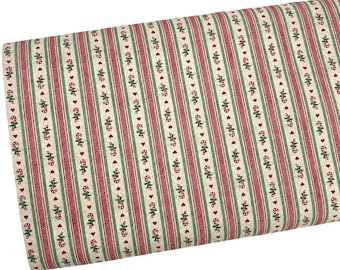 May include: A bolt of fabric featuring a repeating pattern of vertical stripes in red, green, and cream. The design includes alternating bands of solid red, thin green lines, and cream sections decorated with small red hearts and candy canes.