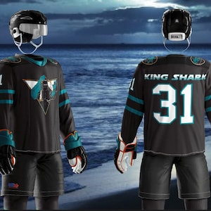 May include: Black hockey jersey with teal and orange accents. The jersey has a shark logo with the text "KING SHARK" and the number "31" on the back.