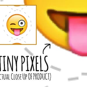 May include: Close-up of a yellow emoji with a winking eye and tongue sticking out. The emoji is made up of tiny pixels, showing the digital nature of the image. The text "TINY PIXELS (ACTUAL CLOSE UP OF PRODUCT)" is below the emoji.