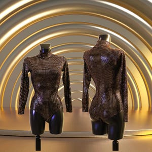 Op de afbeelding: Een langarmige, turtleneck bodysuit met een metallic, gestreept patroon in tinten bruin en goud. De bodysuit wordt getoond op een mannequin tegen een gouden achtergrond.