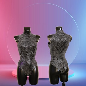 May include: A black sleeveless bodysuit with a mock neck and a silver glitter pattern.