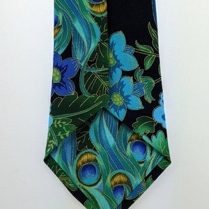 May include: A black necktie with a peacock feather and floral pattern in shades of blue, green, and gold.