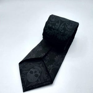 May include: Black tie with a skull and floral pattern.