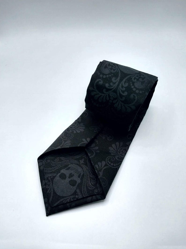 May include: Black tie with a skull and floral pattern.