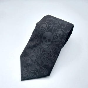 May include: Black tie with a skull and floral pattern.